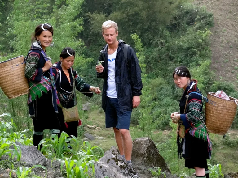 Traveler standing holding a leaf durring a trek