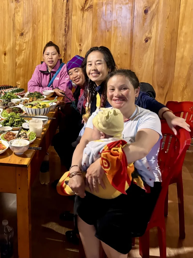 Zao, Chi, Lang and Lan Do, the four founders of Sapa Sisters, at a shared meal in Sapa, northern Vietnam